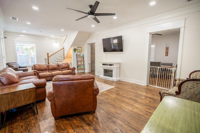 living room with ceiling fan, dark hardwood / wood-style flooring, and crown molding