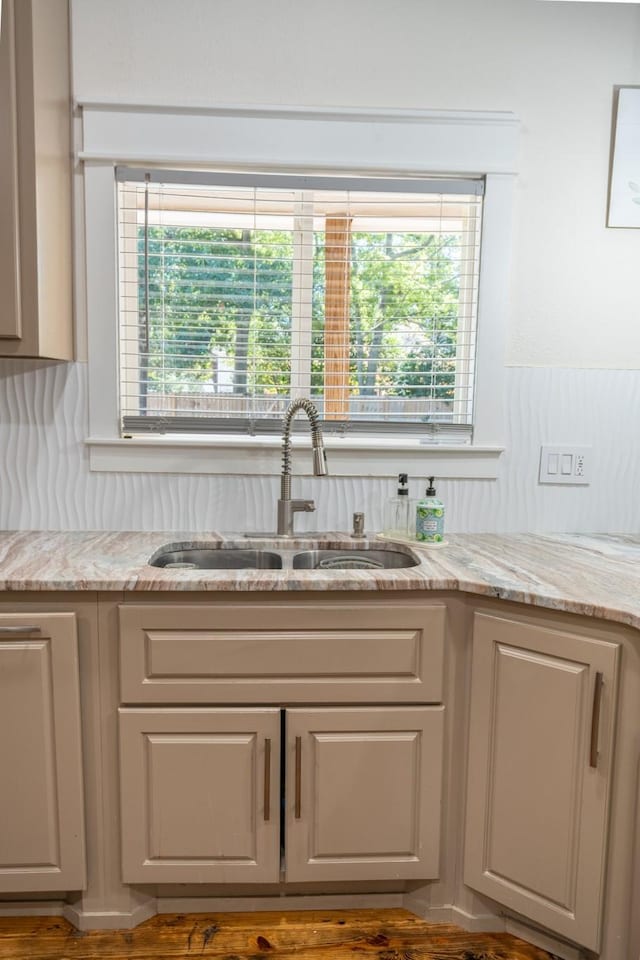 kitchen with sink and light stone countertops