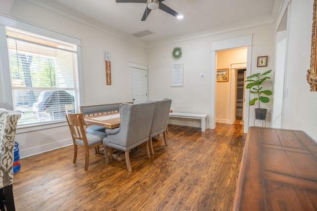 dining area with crown molding, ceiling fan, and dark hardwood / wood-style flooring