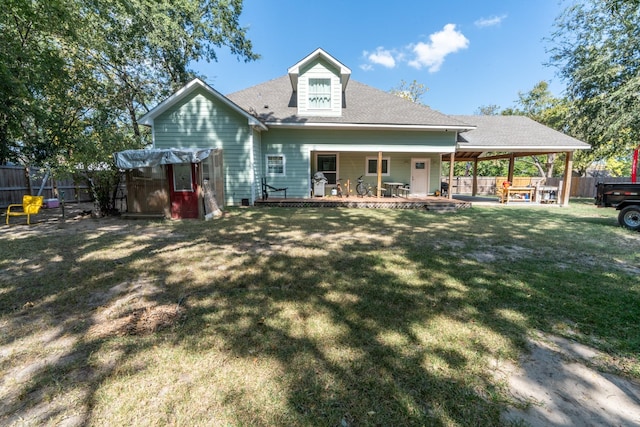 rear view of property with a lawn and a patio