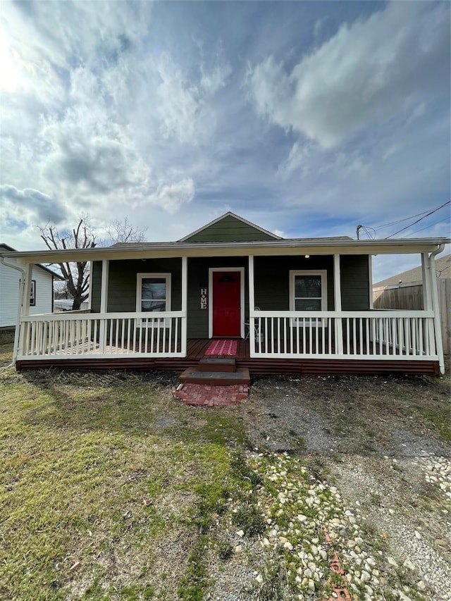 view of front of house with a porch and a front yard