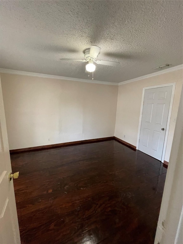 empty room featuring dark hardwood / wood-style flooring, crown molding, a textured ceiling, and ceiling fan