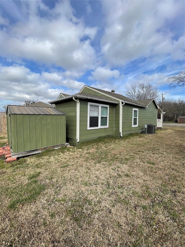 508 N 3rd St, Princeton, TX 75407 - back of house with a storage shed and a lawn