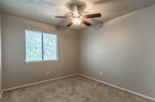 carpeted empty room featuring a textured ceiling