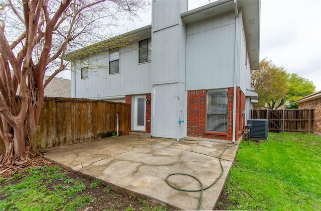 back of property featuring a yard, a patio, and central AC