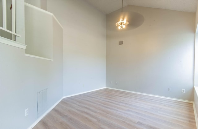 spare room featuring ceiling fan, light hardwood / wood-style floors, and lofted ceiling