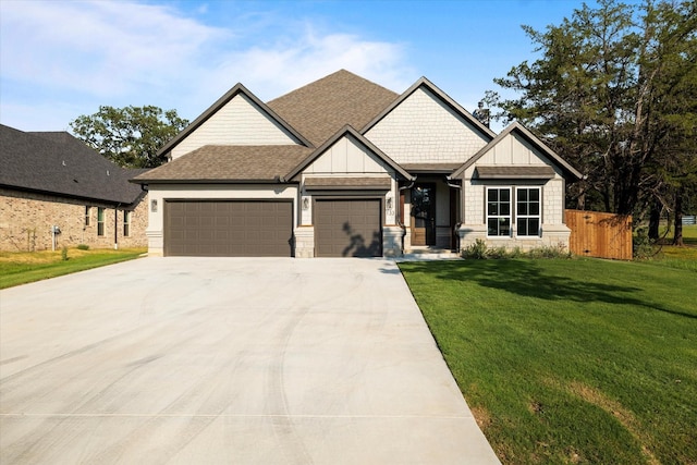 craftsman-style home featuring a garage and a front yard