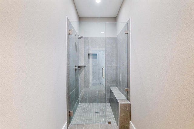 bathroom with tile patterned flooring and a shower with shower door