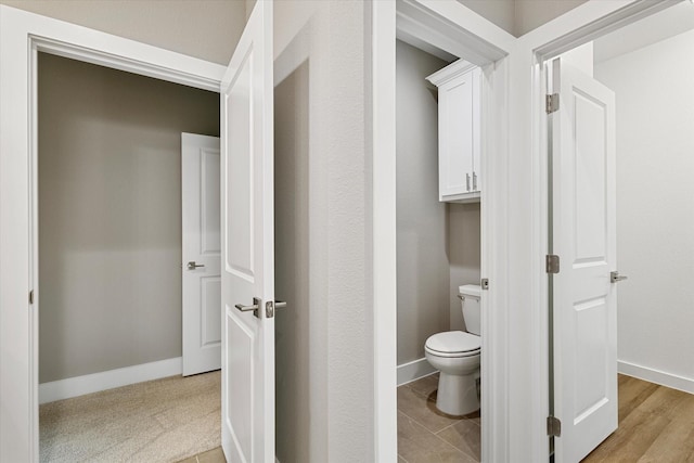 bathroom featuring hardwood / wood-style floors and toilet