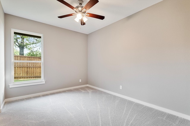 carpeted empty room featuring ceiling fan