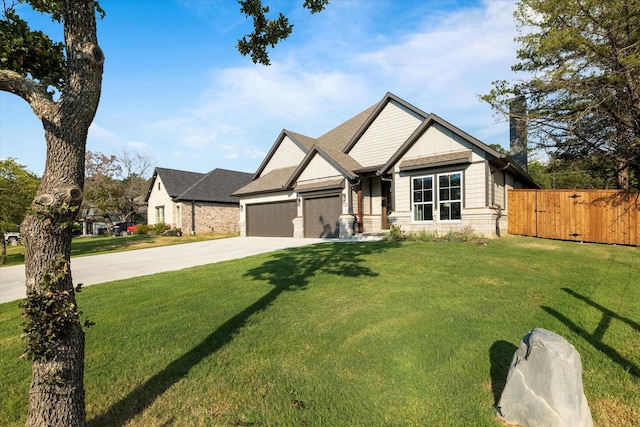 craftsman house with a garage and a front lawn