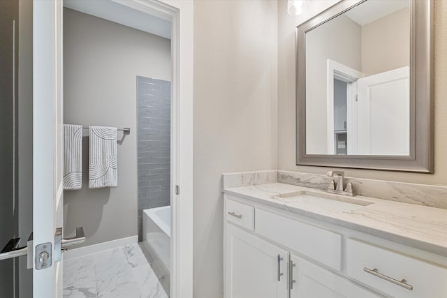 bathroom featuring a washtub and vanity