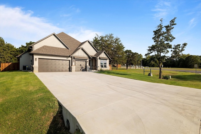 craftsman house with a garage and a front lawn