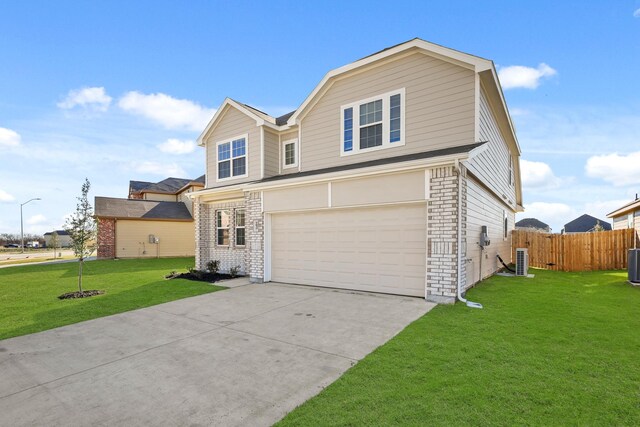 view of front of property featuring cooling unit, a garage, and a front yard