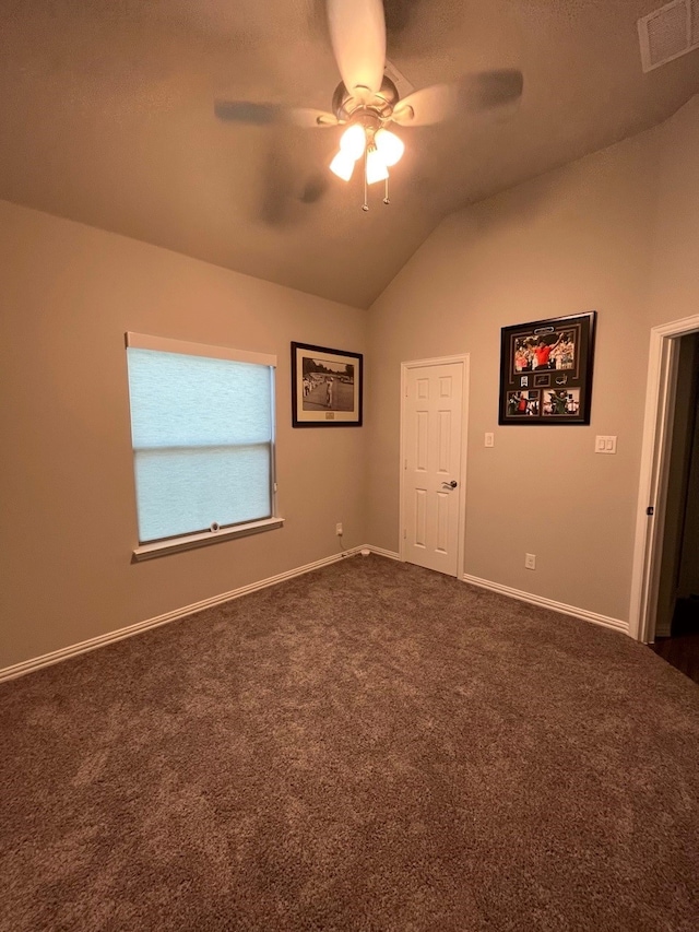 carpeted spare room featuring ceiling fan and lofted ceiling