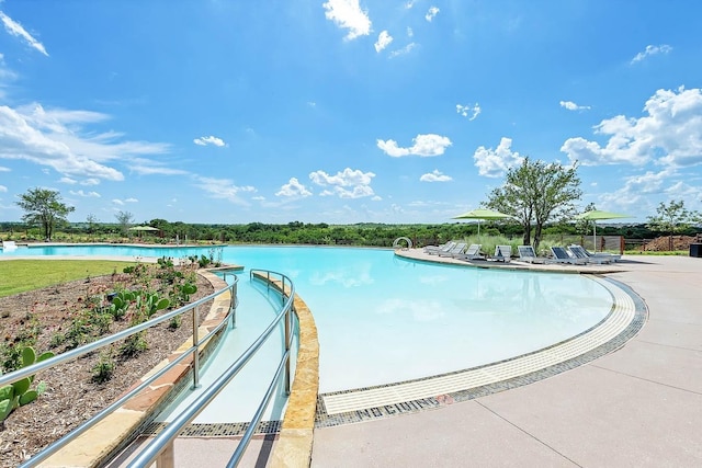 view of swimming pool featuring a water view