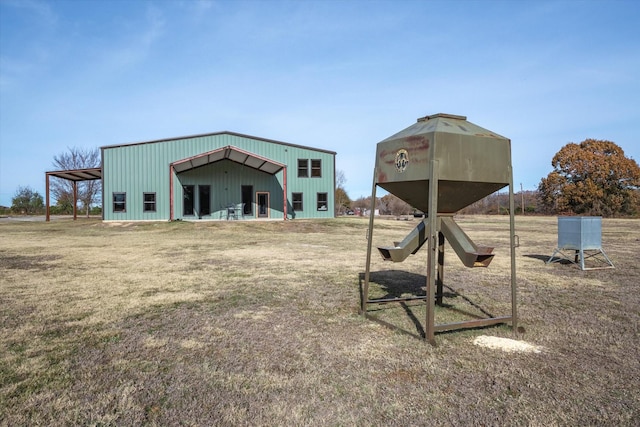 view of yard with a garage and an outbuilding