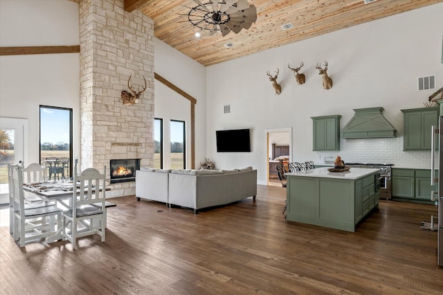 living room featuring wood ceiling, high vaulted ceiling, a stone fireplace, and dark wood-type flooring