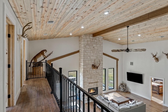 hall featuring beamed ceiling, wooden ceiling, wood finished floors, and visible vents