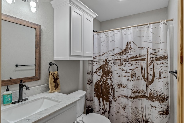 bathroom featuring toilet, a shower with curtain, and vanity