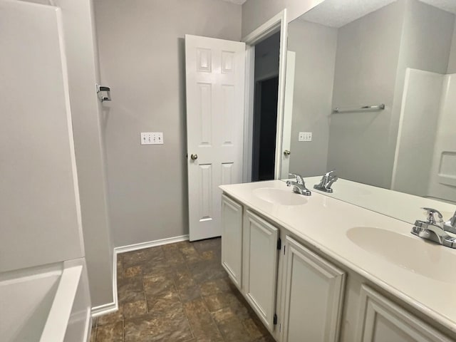 bathroom featuring baseboards and a sink