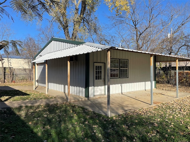 view of outbuilding with an outbuilding and fence