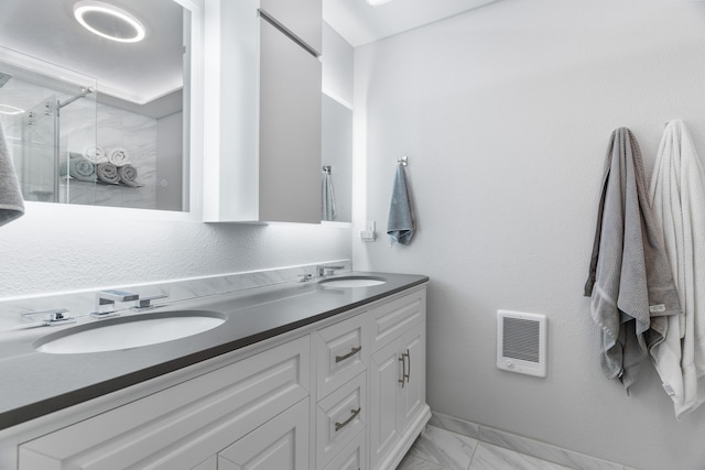 bathroom with vanity and a shower with shower door