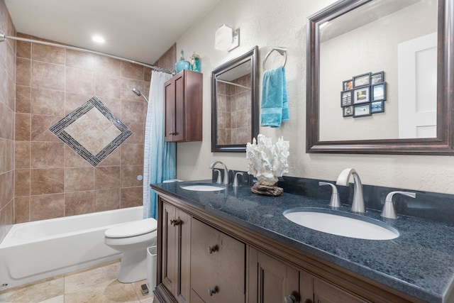 full bathroom with shower / bath combo, vanity, tile patterned floors, and toilet