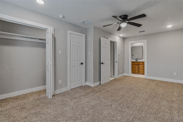 unfurnished bedroom with ceiling fan, carpet floors, sink, and ensuite bath