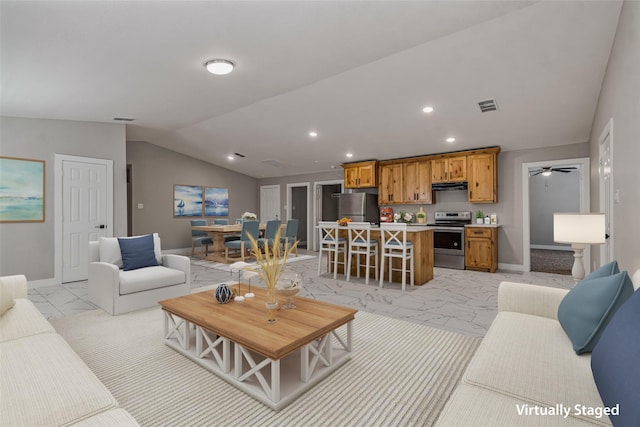 living room with visible vents, baseboards, vaulted ceiling, and marble finish floor