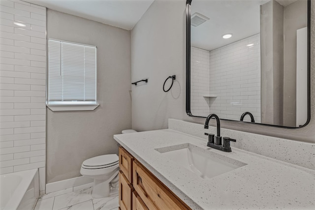 full bathroom with vanity, tiled shower / bath combo, and toilet