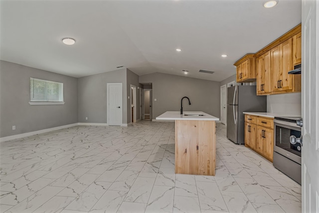 kitchen with lofted ceiling, appliances with stainless steel finishes, sink, and a center island with sink