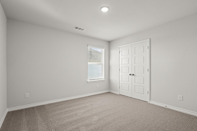 unfurnished bedroom featuring carpet floors and a closet