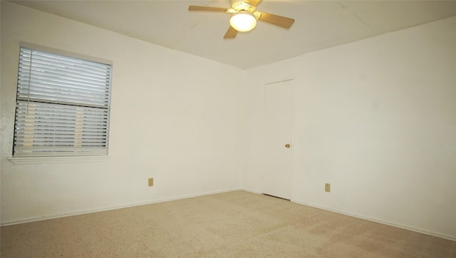 unfurnished room featuring light carpet and ceiling fan