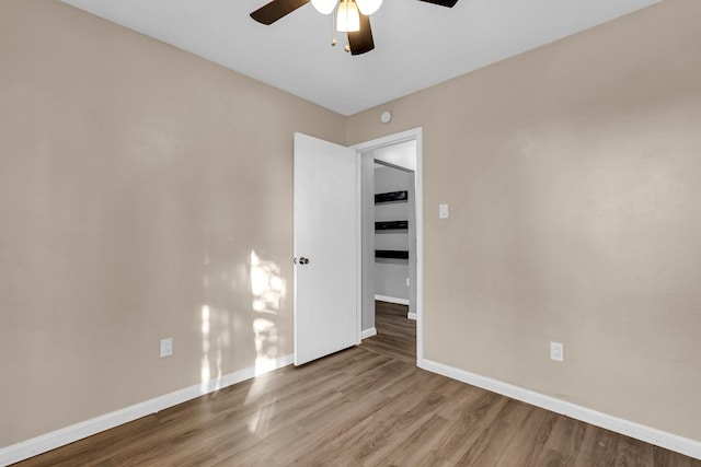 unfurnished room with wood-type flooring and ceiling fan