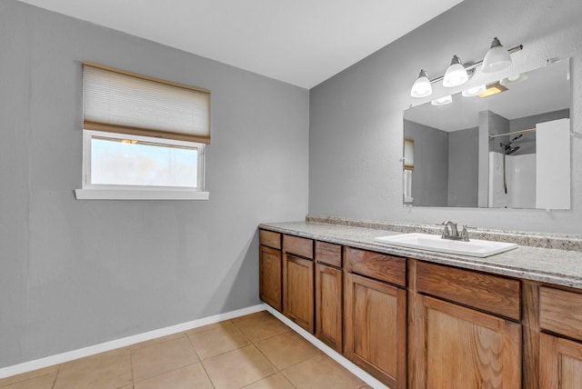 bathroom with a shower, vanity, and tile patterned floors