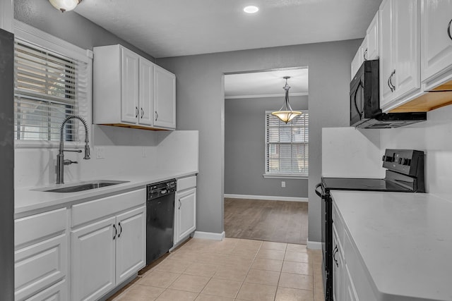 kitchen featuring white cabinets, light tile patterned floors, sink, and black appliances