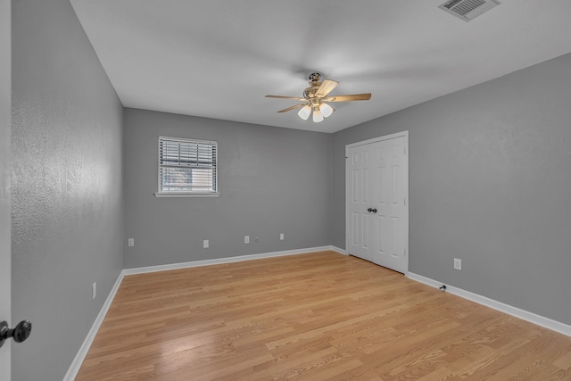 spare room featuring ceiling fan and light hardwood / wood-style flooring