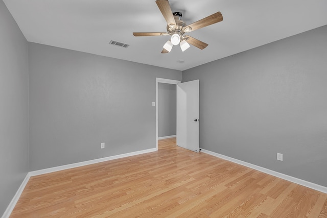 empty room featuring ceiling fan and light hardwood / wood-style flooring