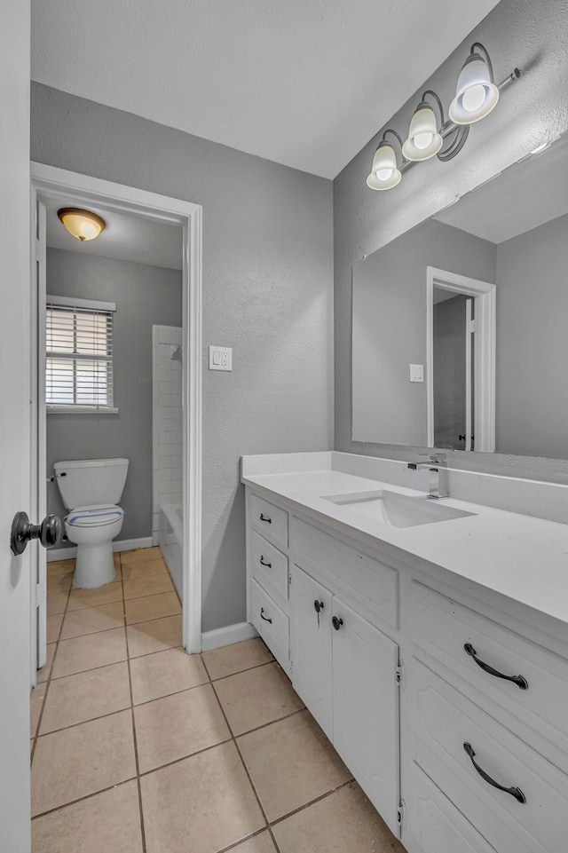 full bathroom with tile patterned flooring, vanity, tub / shower combination, and toilet