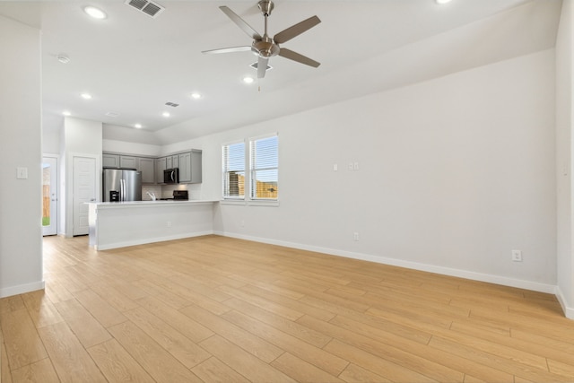 unfurnished living room with ceiling fan and light wood-type flooring