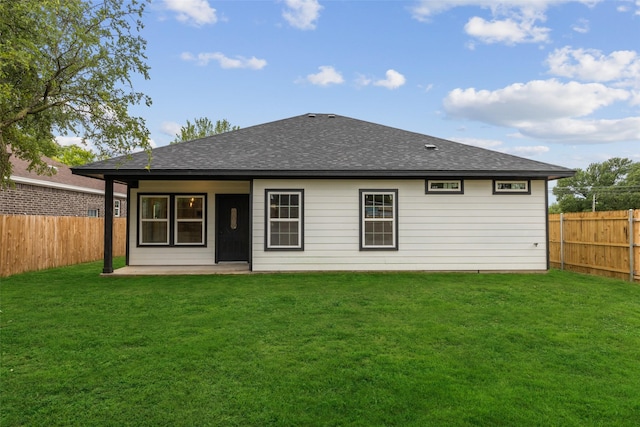 back of house featuring a yard and a patio