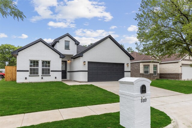 view of front facade with a front yard and a garage