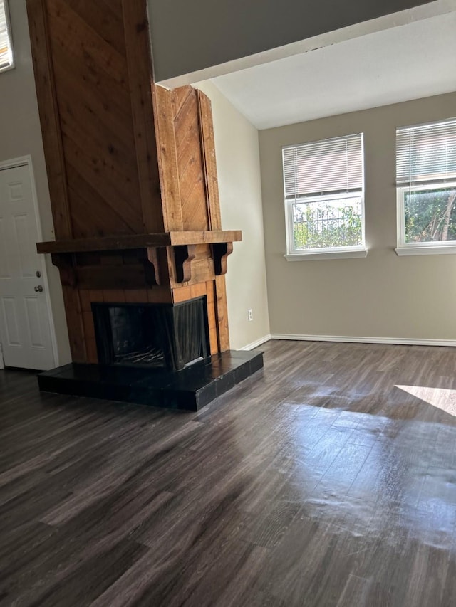 unfurnished living room featuring dark hardwood / wood-style flooring and a fireplace