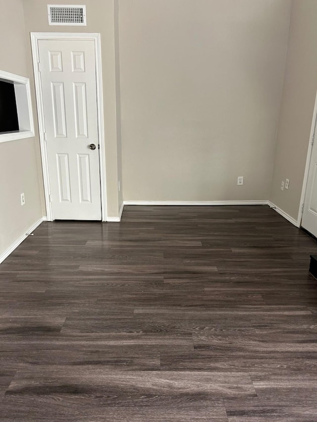 unfurnished room featuring dark hardwood / wood-style flooring