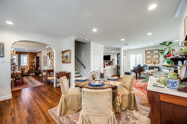 dining space featuring dark hardwood / wood-style flooring and crown molding