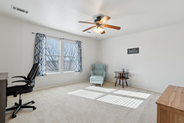 office space with light carpet and ceiling fan