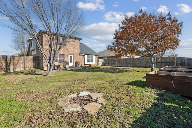 view of yard featuring a fire pit and a patio