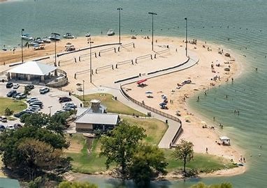 birds eye view of property with a water view and a beach view