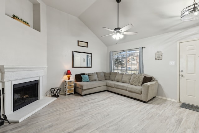 living room featuring light wood-type flooring, high vaulted ceiling, and ceiling fan